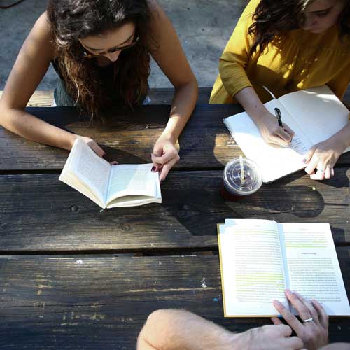 young people at a desk writing