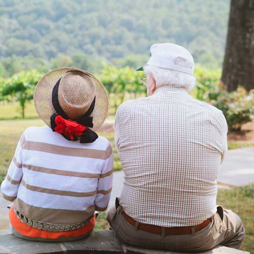 older couple sitting with a great nature view