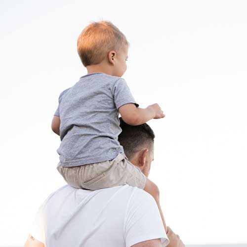 baby sitting on his fathers shoulders