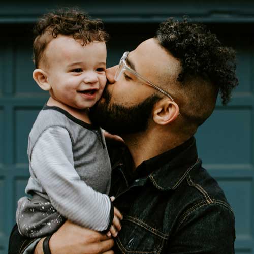 father holding his toddler child